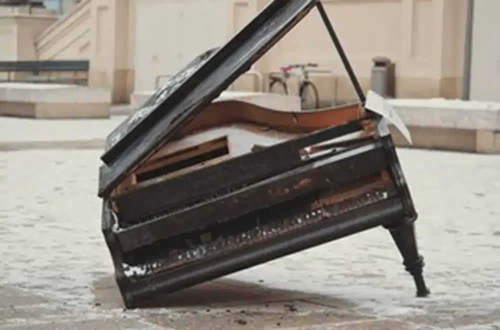 a dropped piano with a broken leg